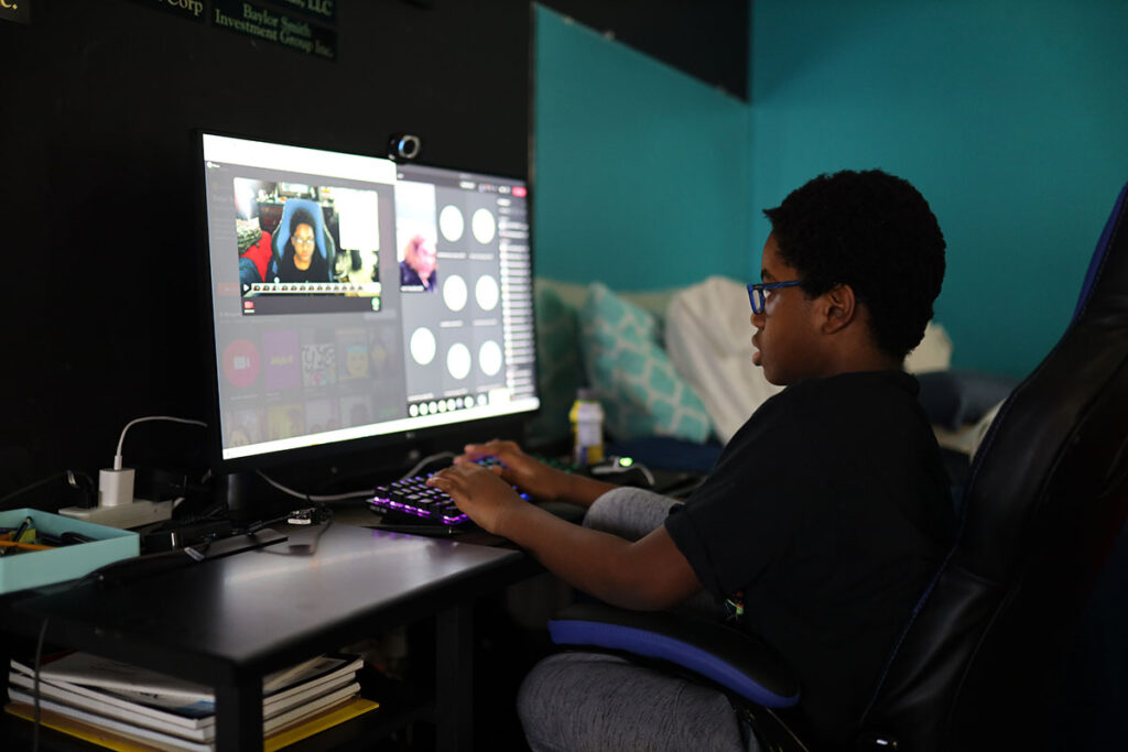 A student works on a a graphics project on the computer.