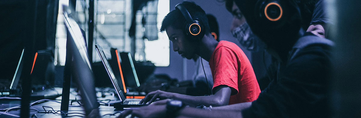 Students in headphones work on projects in the computer lab.